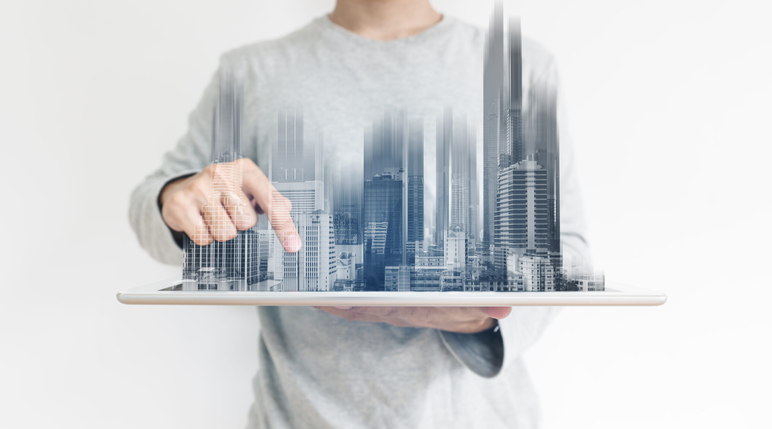 A,Man,Using,Digital,Tablet,,And,Modern,Buildings,Hologram.,Real